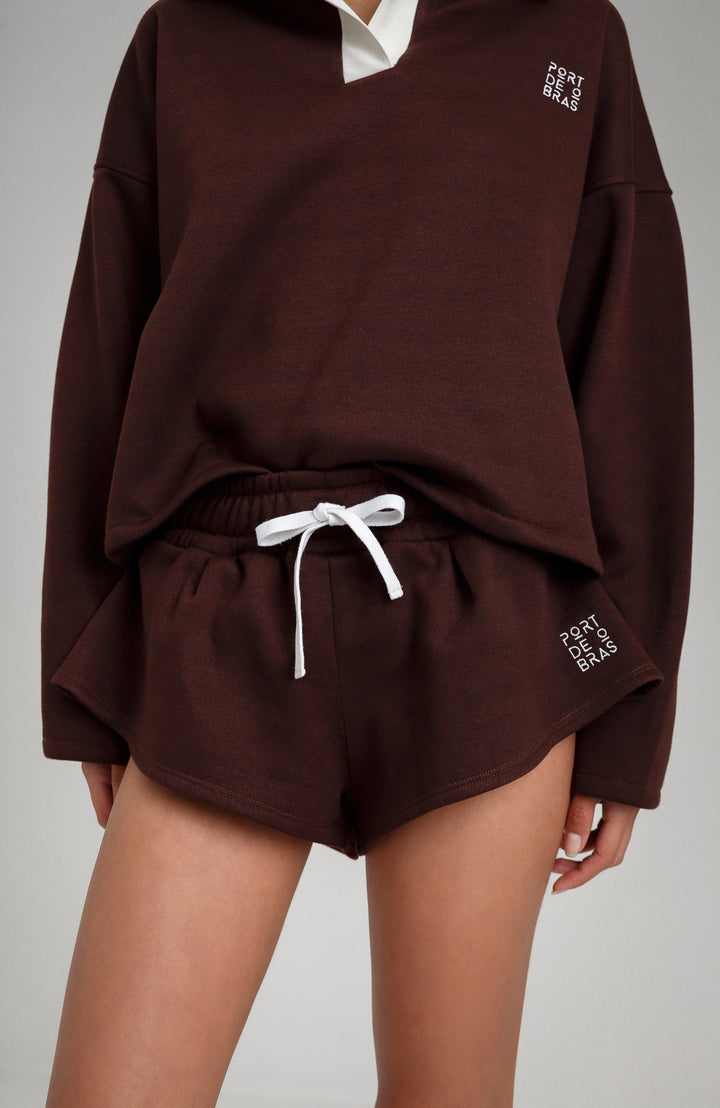 Brown sweatshirt and shorts set with white drawstring on a gray background